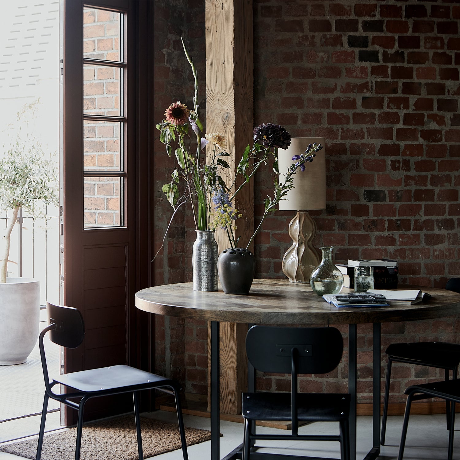 Round dining table with chairs and flower arrangements